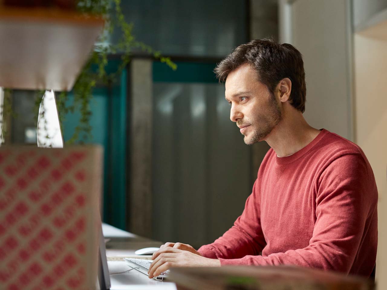 man typing on his computer